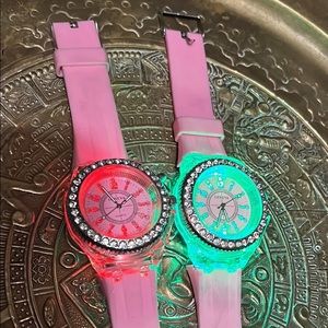 2 flashing up Light changing pink watches.